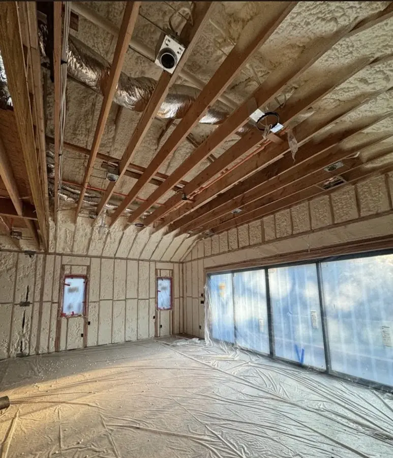 Interior walls and ceiling insulated with spray foam during new construction in West Warwick